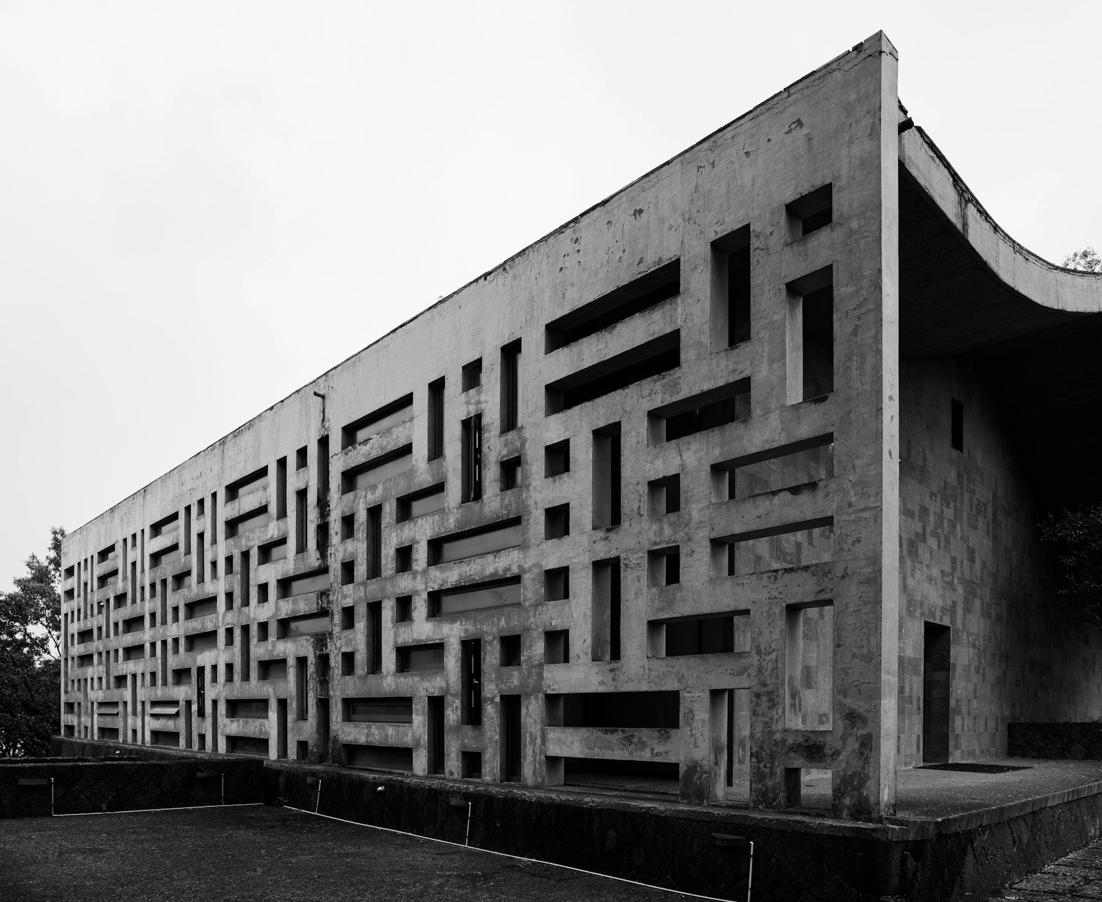 A long building with a deep geometric facade pattern