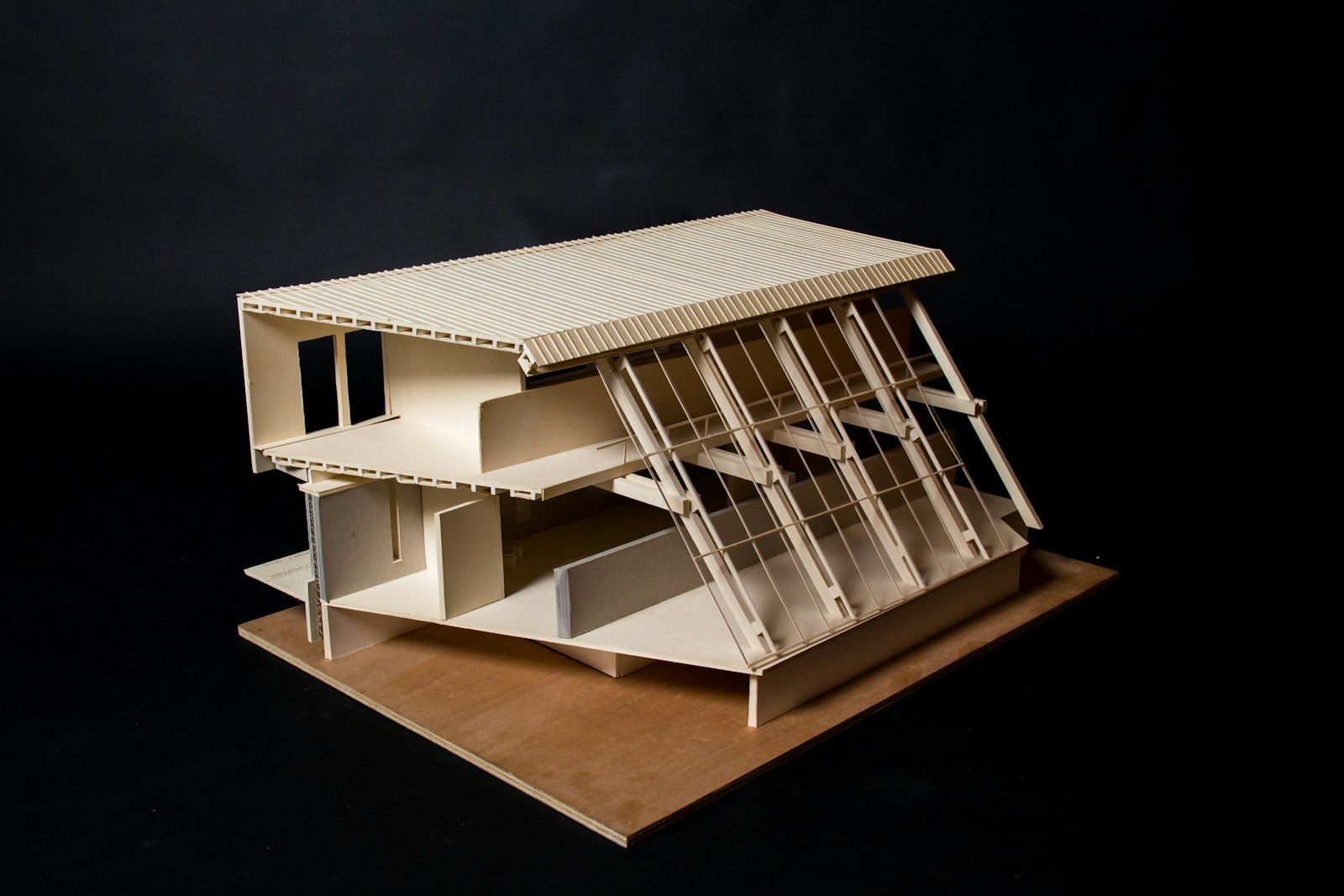 A detailed architectural model on a dark table